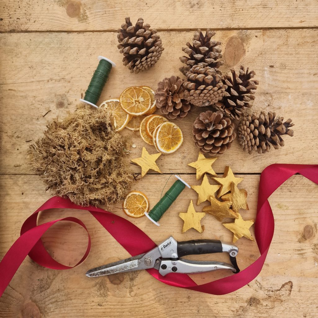 Craft table with items to make a christmas wreath