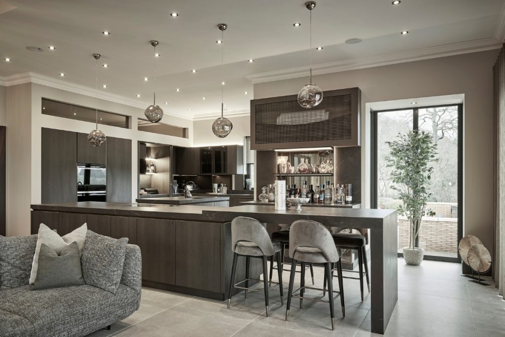 A modern kitchen with a kitchen island and a bar in the background